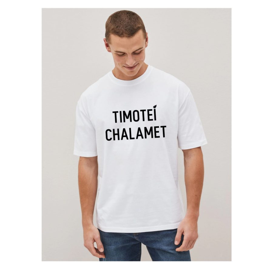 Colour photograph of a man wearing a large white t-shirt with the words Timotei Chalamet print in black on the front.  He has bare arms and is in his twenties.  On the right handside there is a black and white photograph of a young woman in jeans, vest top and with two plaits crossing a grand street in Bilbao Spain.