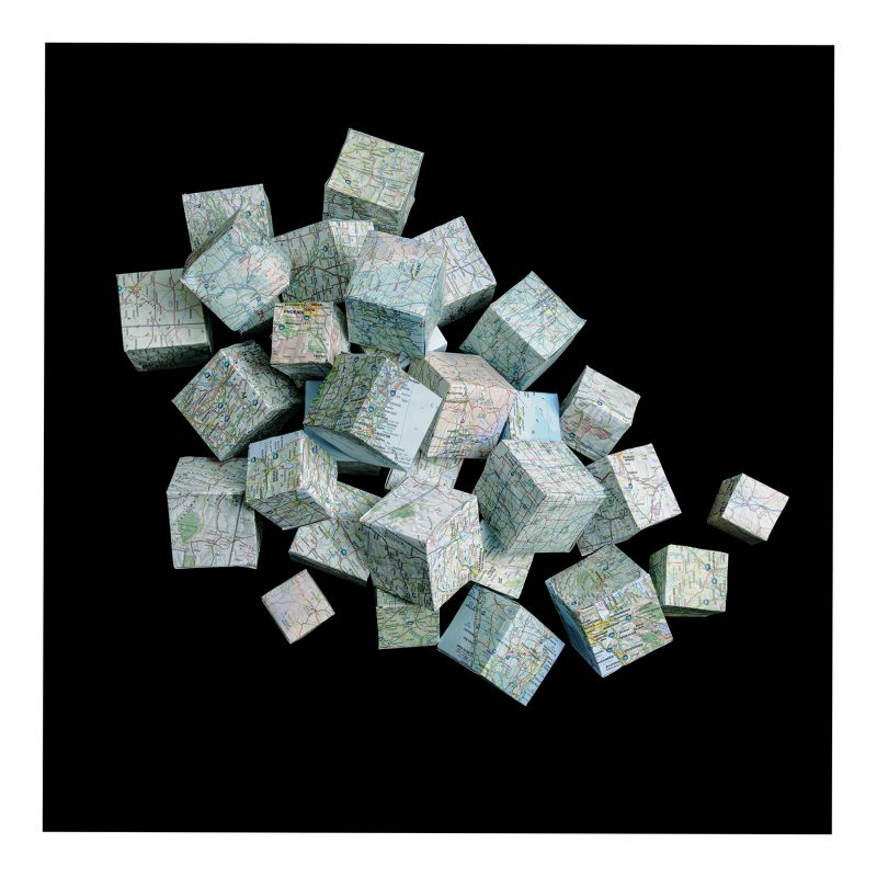 Cubes created from a map of the USA appear to be tumbling across a black background.