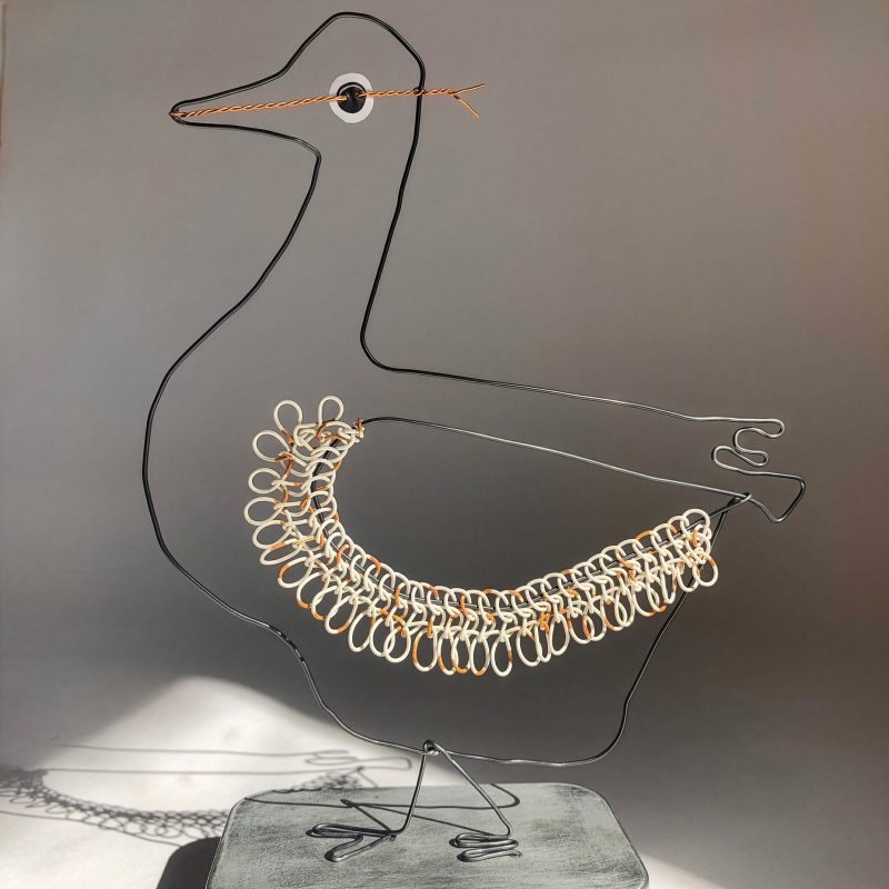 A continuous line sculpture of a goose, with a wing embellished with recycled telephone wire.