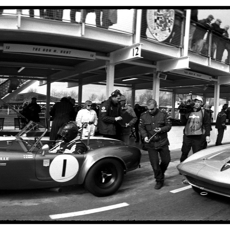 Panoramic black and white photograph of the Goodwood pitlane.