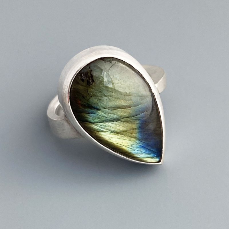 Very fine blue green pear cabochon labradorite on a chunky sterling silver ring