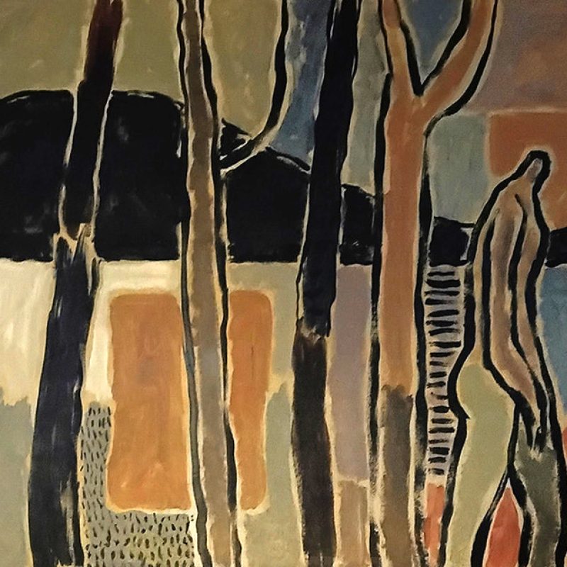 Figure walks past 4 trees and estuary