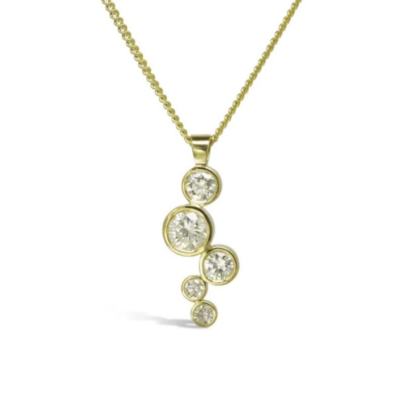 A drop pendant with round diamonds in gold settings in a staggered arrangement