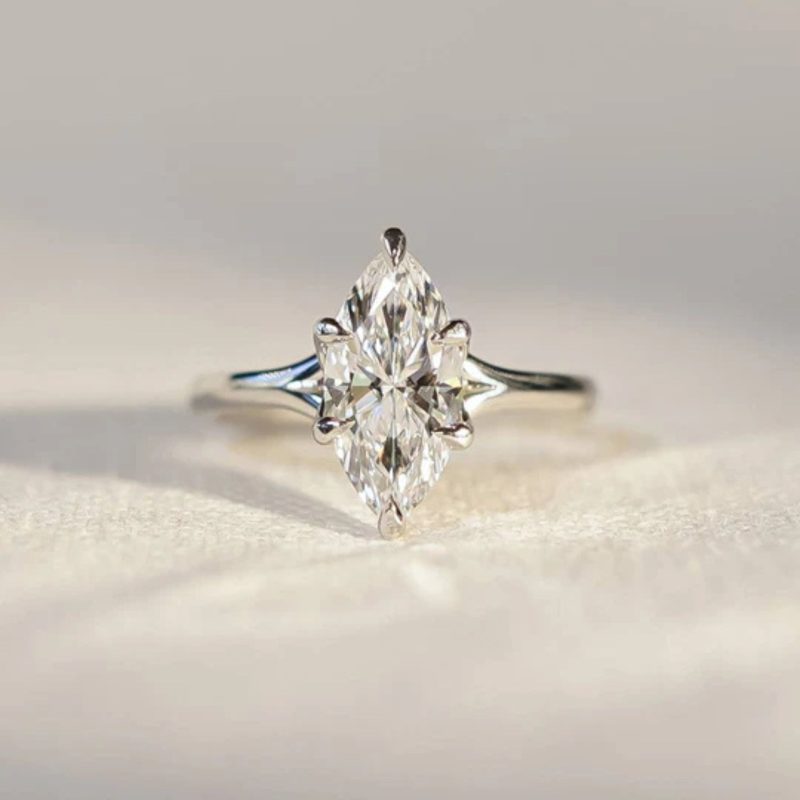 A marquise shaped diamond in a platinum tulip shaped claw set mount