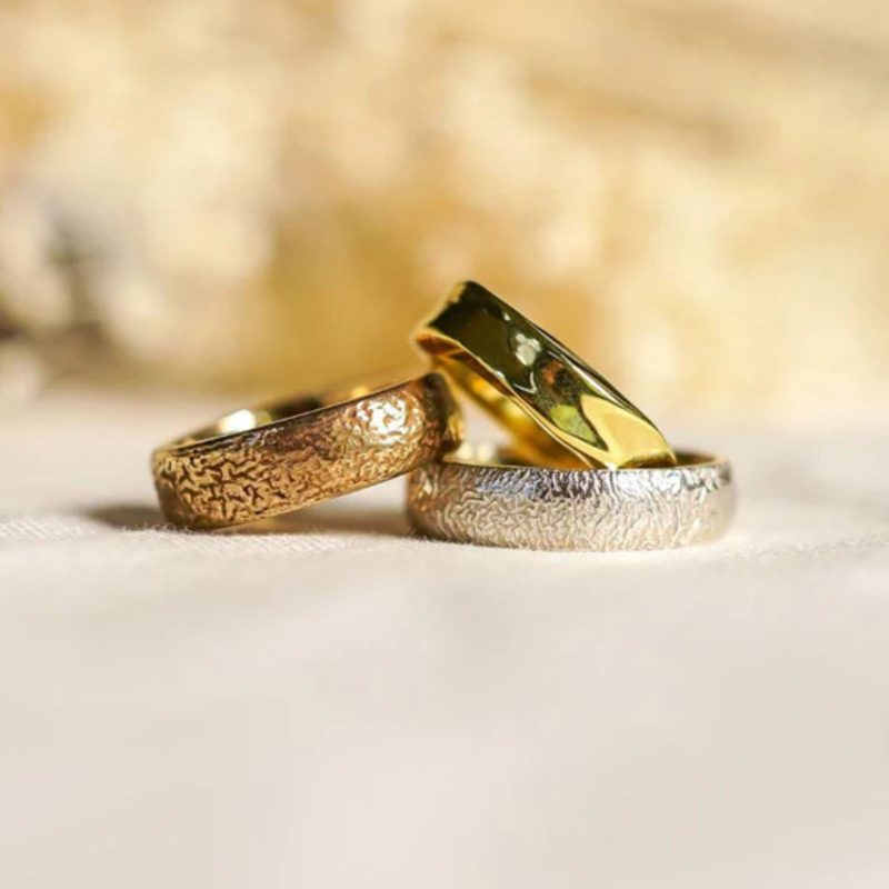 Assorted handmade wedding rings, some textured