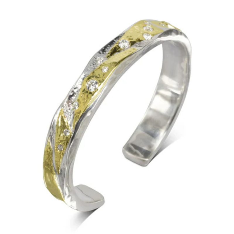A hammered Silver and Yellow Gold Diamond Cuff Bangle set with a scatter of different sized round diamonds