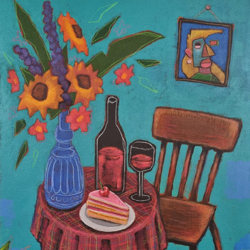 A colourful painting shows a small round table covered with a red plaid tablecloth. On the table are a slice of layered cake on a white plate, a glass of red wine, and a wine bottle. Next to the bottle is a blue decorative vase holding an arrangement of tall flowers, including sunflowers and pink blossoms. A wooden chair sits beside the table. The background is a teal blue wall with a framed abstract portrait featuring geometric shapes and bright colours. Green leaves and plants appear in the corners of the painting.