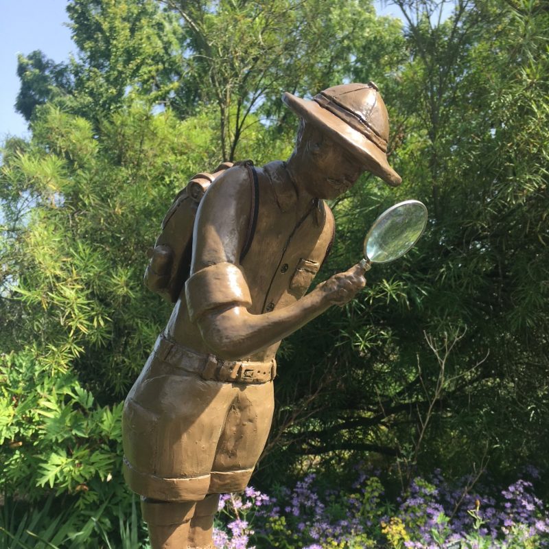 Metal figure with magnifying glass 