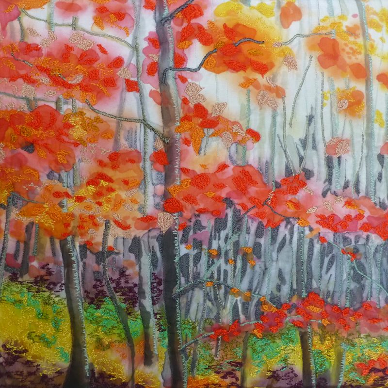 A woodland scene painted on silk and embroidered with a main narrow tree trunk just left of centre and foilage in shades of red and orange on horizontal branches with raised quilted areas