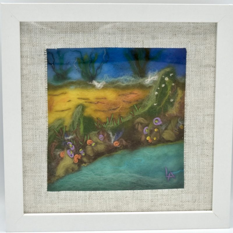 A square landscape scene with the sea in front, sand and sea plants against a blue sky.