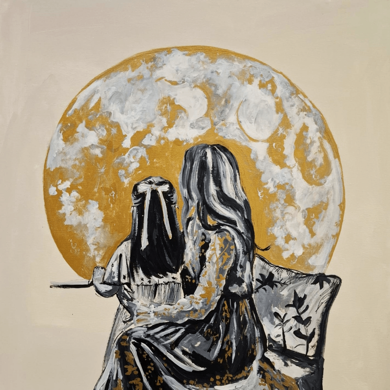 A mother holding a little girl in her lap while they look at the moon