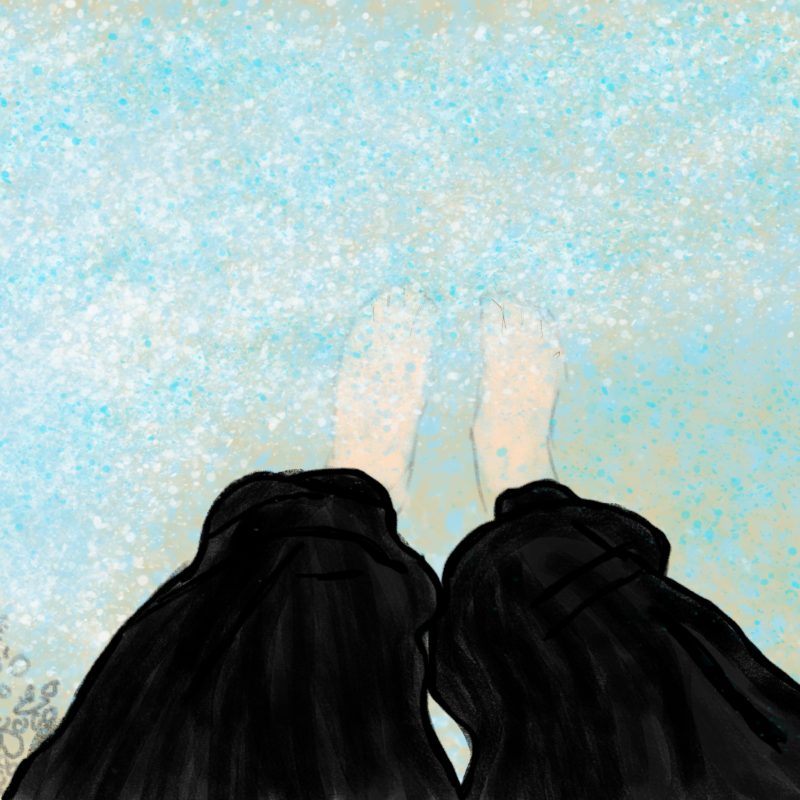 A pair of feet dipping into water