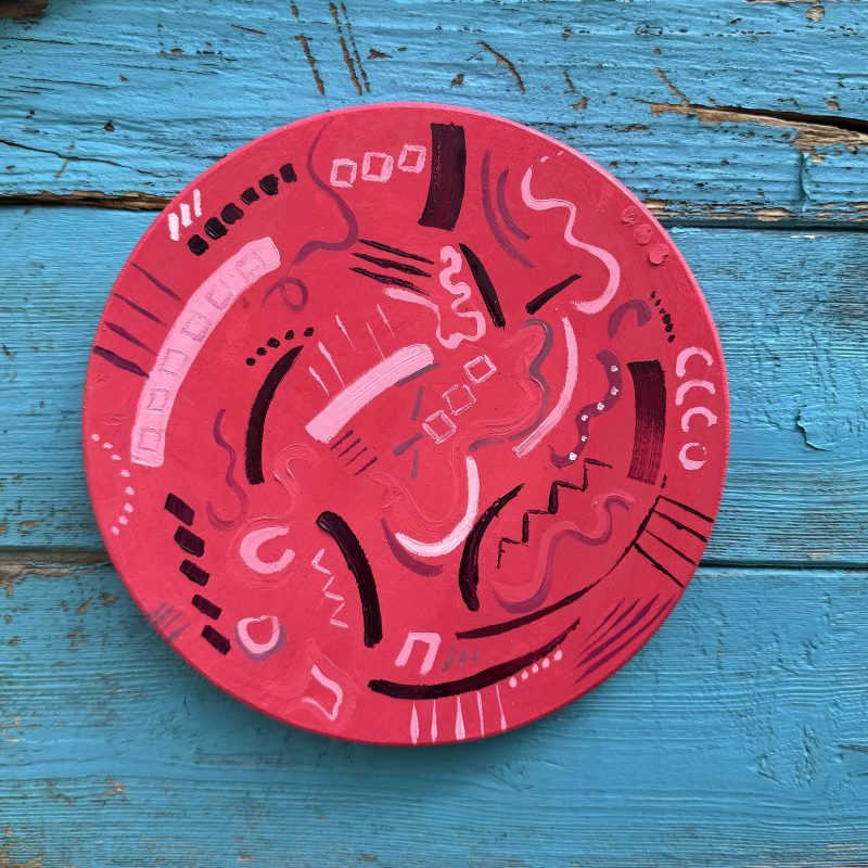 Pink circle with abstract musical marks 