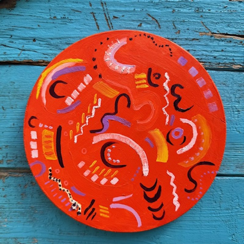 Bright orange disc with abstract musical marls 