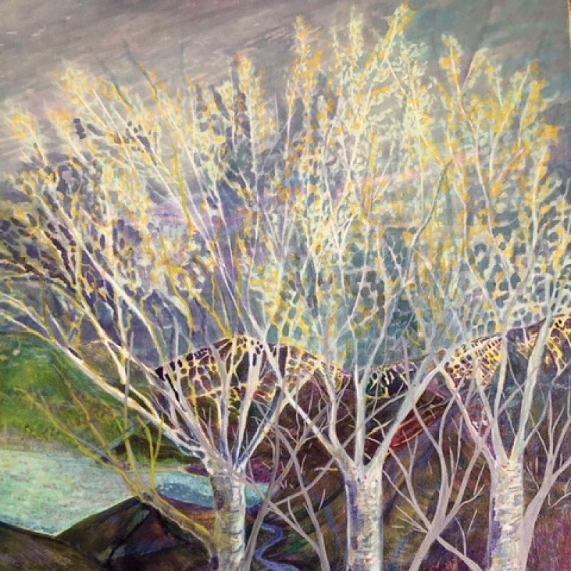 Three trees with spring leaf stand stall above a scene of hills and water