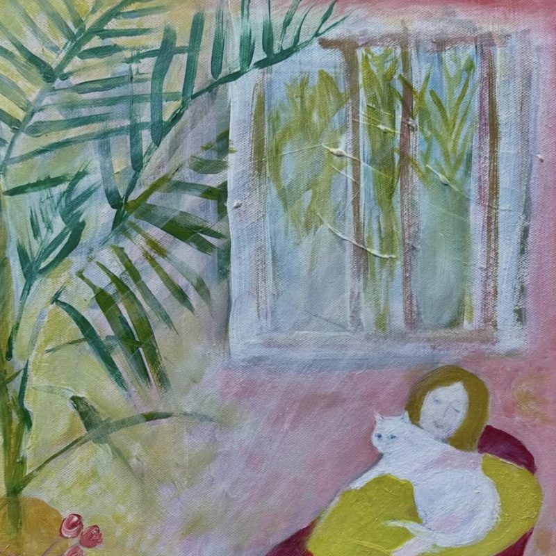 Lady with white cat sitting by window and palm plant