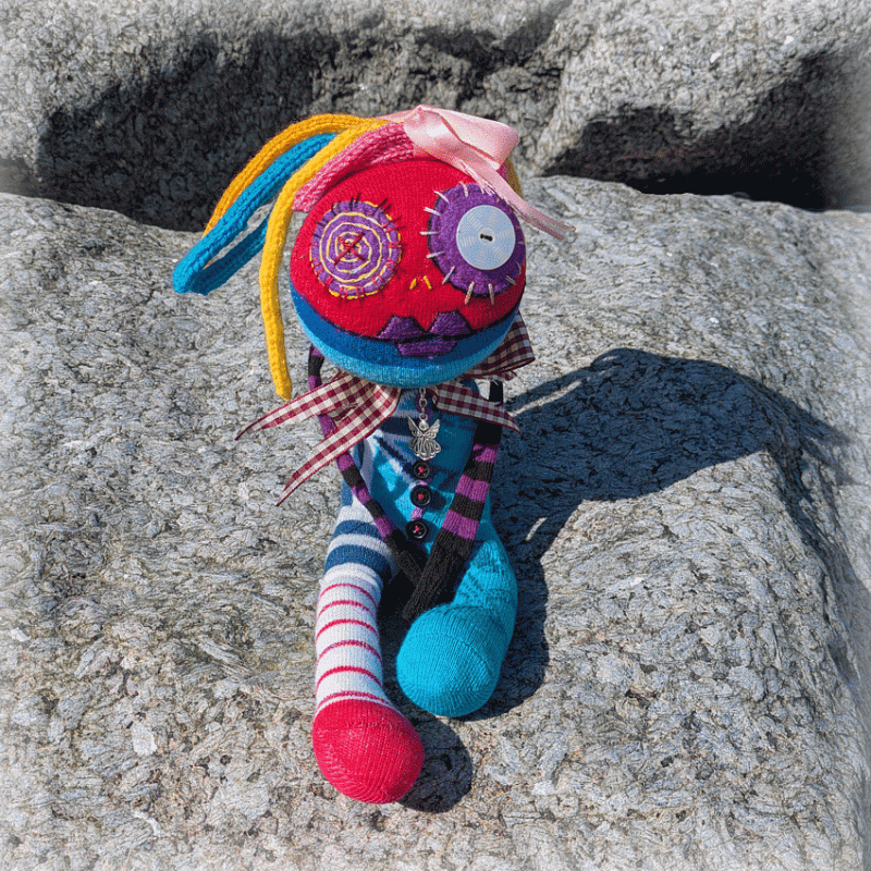 Handmade colourful textile art doll