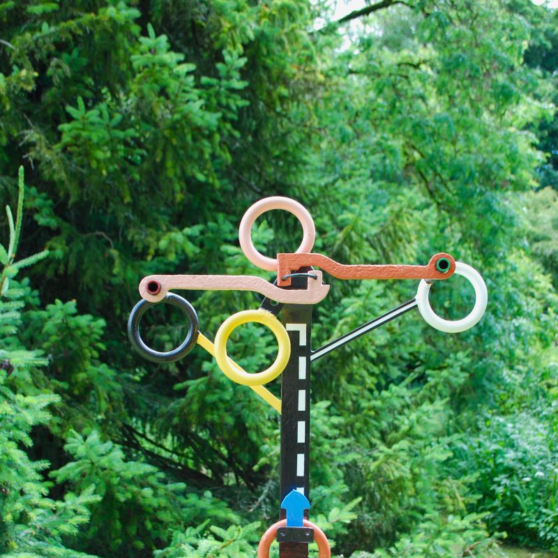 A small abstract sculpture of ring forms and road references 