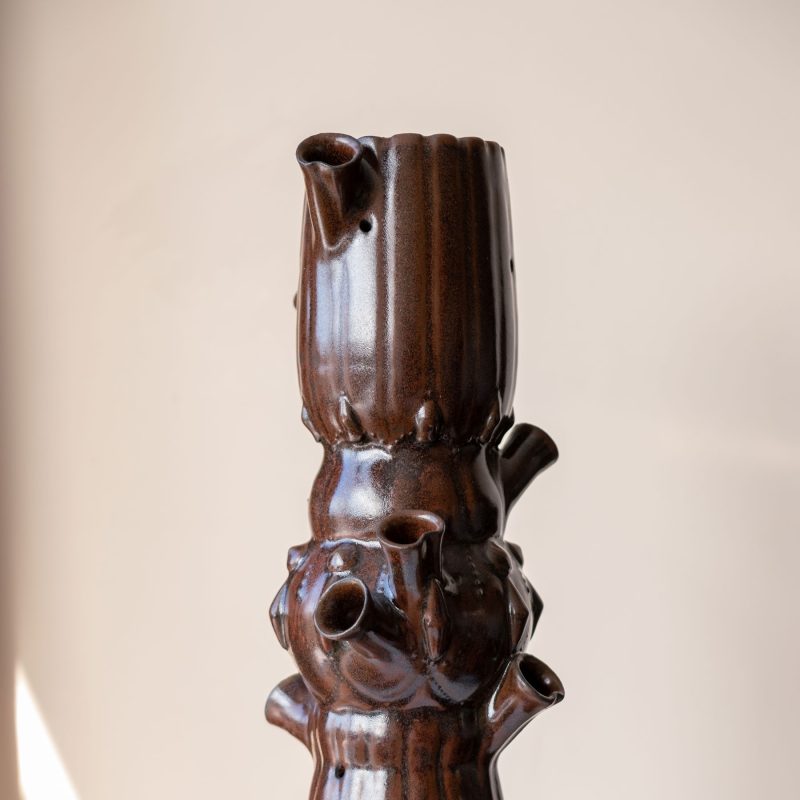 Tall Vase with texture and brown glaze, multiple openings and spouts for placing flowers.