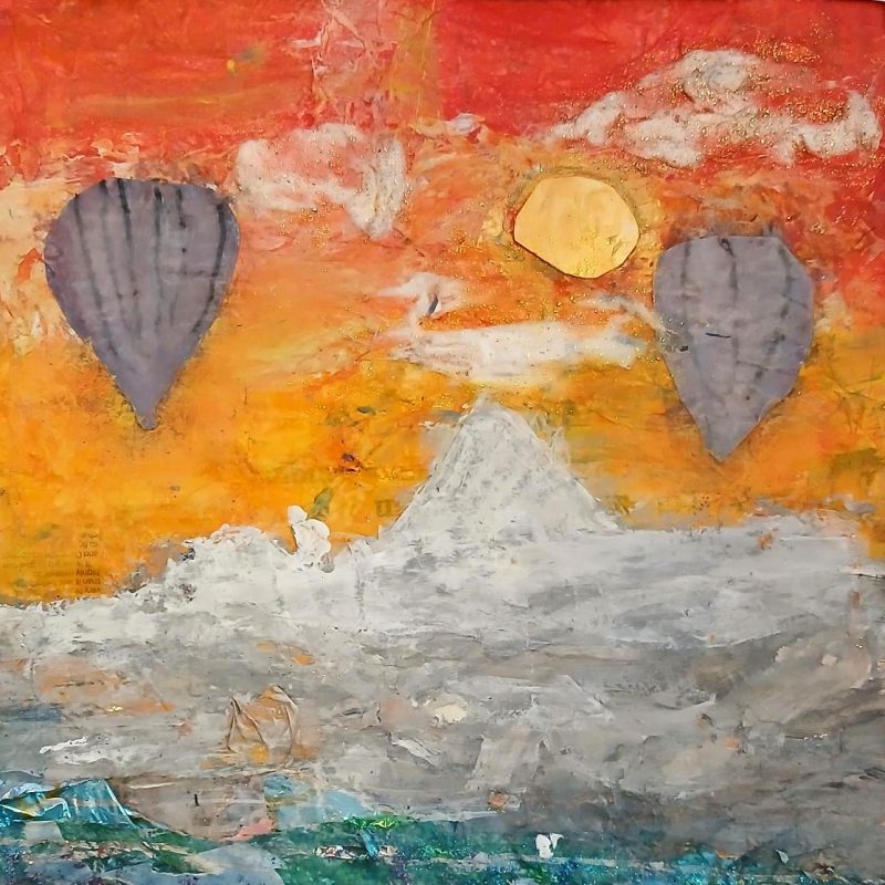 Under a red sky, sunrise, two air balloons flying.